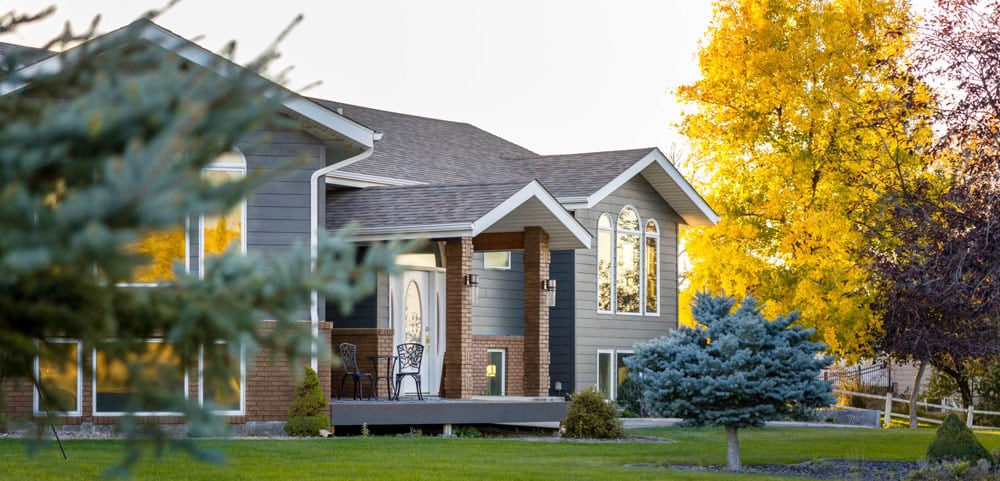 Exterior shot of a large home with gray siding in the Central Wisconsin town Stevens Point.